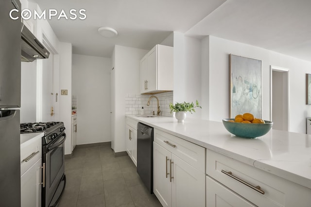 386 Columbus Ave Unit 2A, New York City, NY 10024 - kitchen with stainless steel gas range oven, black dishwasher, a sink, white cabinetry, and backsplash
