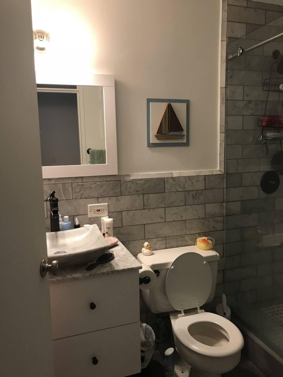 225 E 86th St Unit 304, New York City, NY 10028 - full bath featuring vanity, tile walls, a shower stall, toilet, and a wainscoted wall