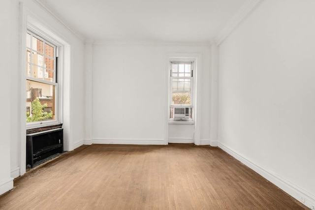 150 E 72nd St Unit 6S, New York City, NY 10021 - unfurnished living room featuring crown molding, wood finished floors, and baseboards