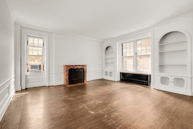 150 E 72nd St Unit 6S, New York City, NY 10021 - unfurnished living room featuring built in features, dark wood-style floors, ornamental molding, a premium fireplace, and cooling unit