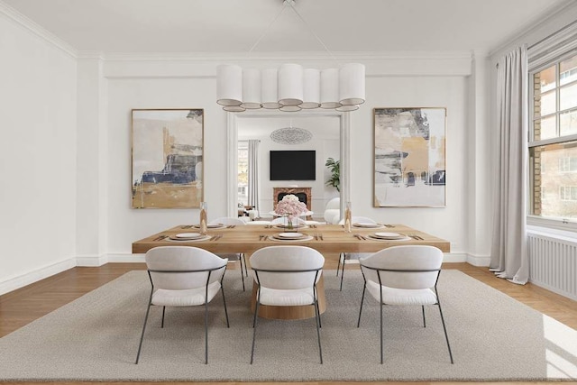 150 E 72nd St Unit 6S, New York City, NY 10021 - dining area with radiator, wood finished floors, ornamental molding, and baseboards