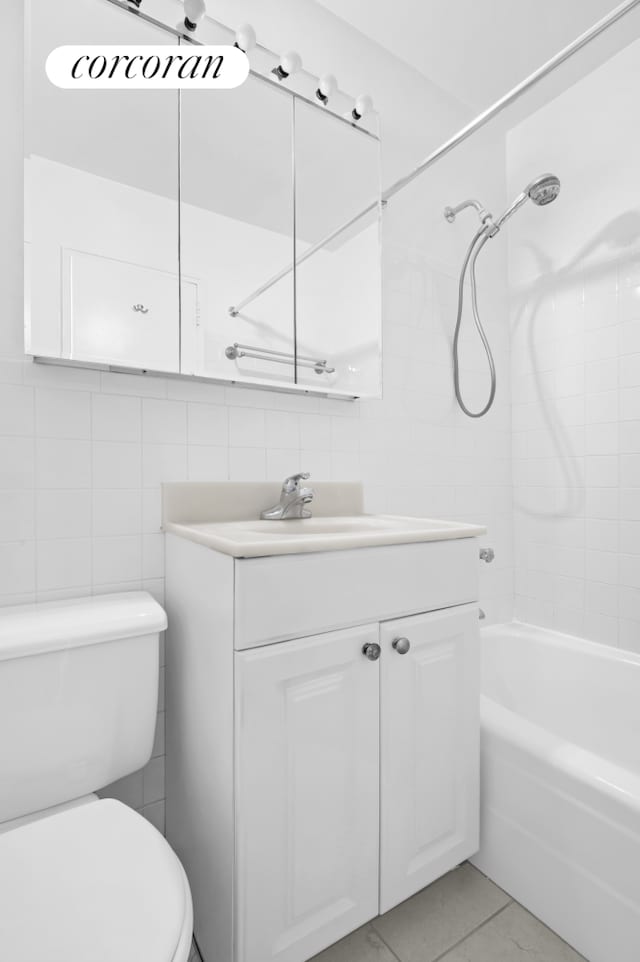 205 W End Ave Unit 9R, New York City, NY 10023 - full bathroom with tile walls, vanity, toilet, shower / bathtub combination, and tile patterned flooring
