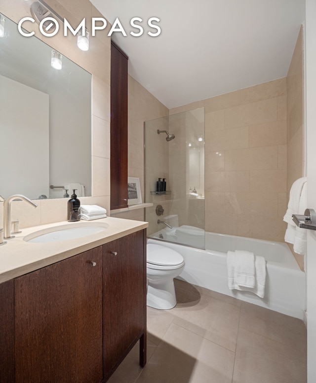205 E 59th St Unit 14B, New York City, NY 10022 - bathroom with vanity, toilet, tile patterned flooring, and washtub / shower combination