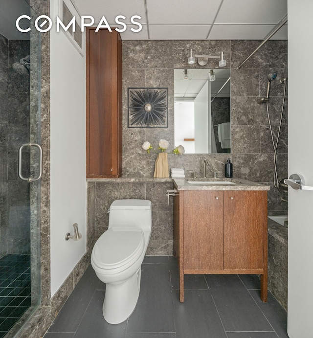 205 E 59th St Unit 14B, New York City, NY 10022 - full bath with vanity, toilet, tile walls, tile patterned flooring, and tiled shower / bath