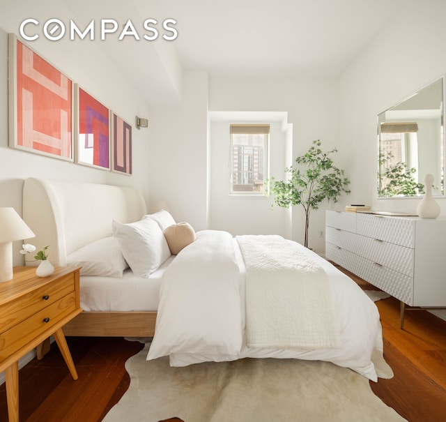 205 E 59th St Unit 14B, New York City, NY 10022 - bedroom featuring multiple windows and wood finished floors