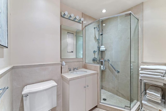 575 Park Ave Unit 507, New York City, NY 10065 - full bath featuring vanity, a stall shower, toilet, tile walls, and recessed lighting