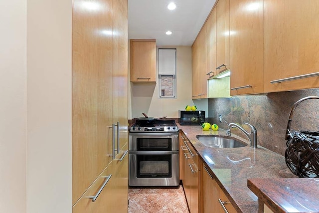 575 Park Ave Unit 507, New York City, NY 10065 - kitchen featuring range with two ovens, black microwave, dark stone countertops, a sink, and recessed lighting