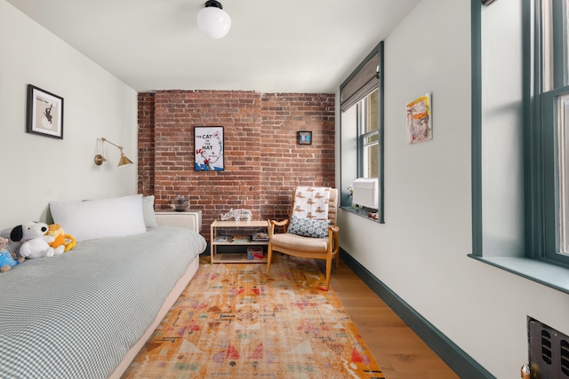 15 Jones St Unit 6A, New York City, NY 10014 - bedroom with brick wall and wood finished floors