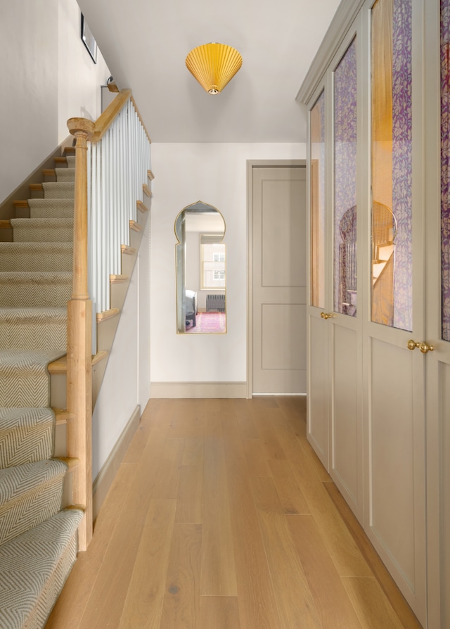 15 Jones St Unit 6A, New York City, NY 10014 - hall with light wood-style flooring, stairway, and baseboards