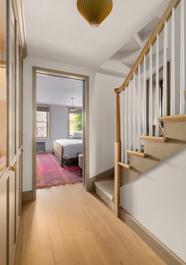 15 Jones St Unit 6A, New York City, NY 10014 - staircase with wood finished floors, radiator, and baseboards