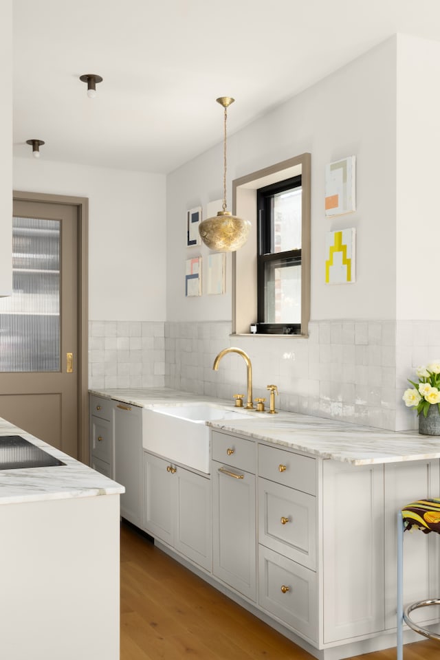 15 Jones St Unit 6A, New York City, NY 10014 - kitchen featuring plenty of natural light, decorative backsplash, light stone countertops, and light wood finished floors