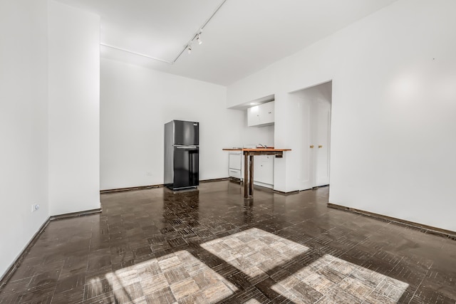 263 Bennett Ave Unit 1C, New York City, NY 10040 - spare room with track lighting and baseboards