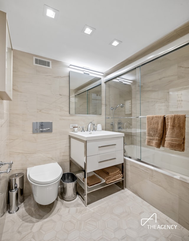 303 W 80th St Unit 2B1B, New York City, NY 10024 - bathroom with tile walls, toilet, tiled shower / bath, vanity, and tile patterned floors