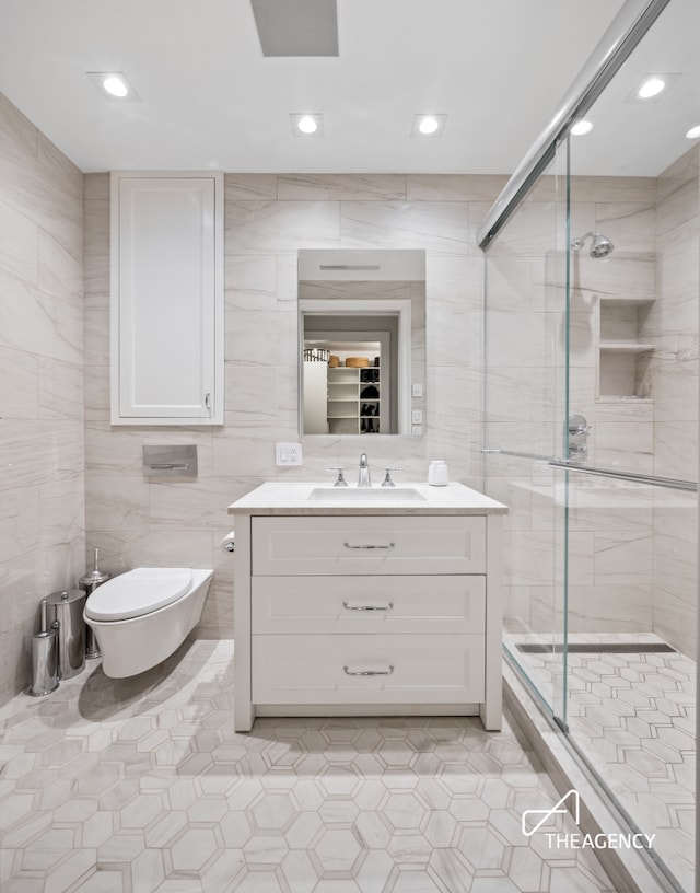 303 W 80th St Unit 2B1B, New York City, NY 10024 - bathroom featuring tile walls, vanity, a stall shower, tile patterned flooring, and recessed lighting