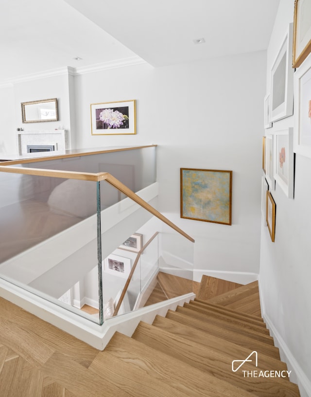 303 W 80th St Unit 2B1B, New York City, NY 10024 - stairs featuring baseboards, crown molding, a fireplace, and wood finished floors