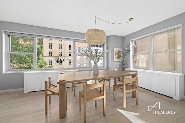 130 E 63rd St Unit 4E, New York City, NY 10065 - dining area with light wood-style flooring and a chandelier