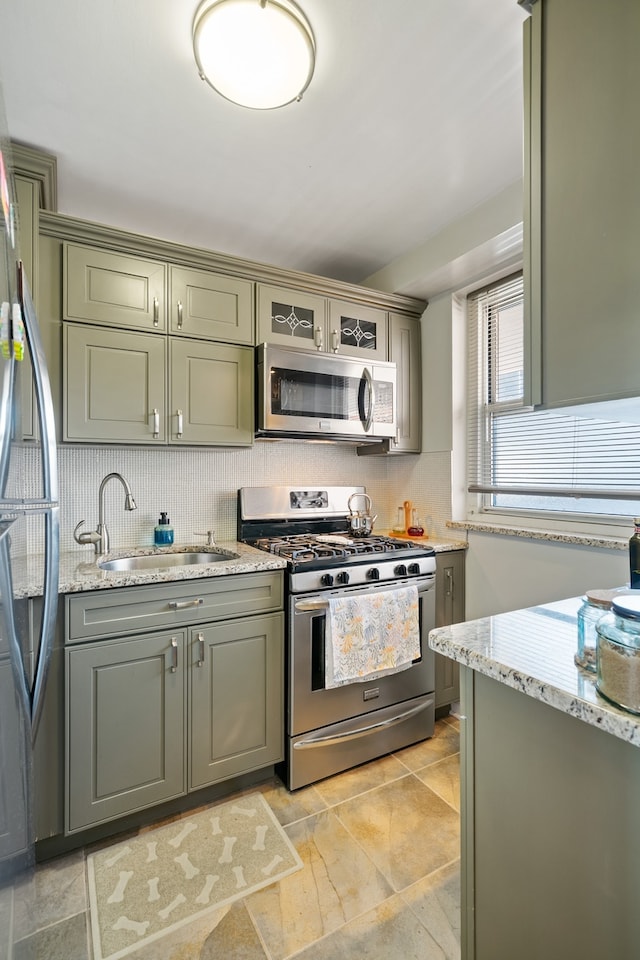35-31 85th St Unit 8-L, New York City, NY 11372 - kitchen with appliances with stainless steel finishes, a sink, tasteful backsplash, and gray cabinetry