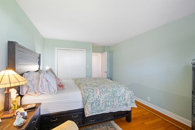 35-31 85th St Unit 8-L, New York City, NY 11372 - bedroom featuring baseboards, a closet, and wood finished floors