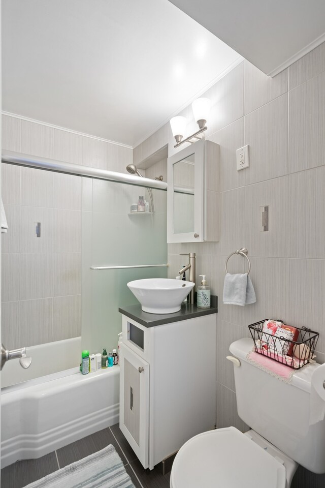 35-31 85th St Unit 8-L, New York City, NY 11372 - bathroom with vanity, bathtub / shower combination, toilet, and ornamental molding