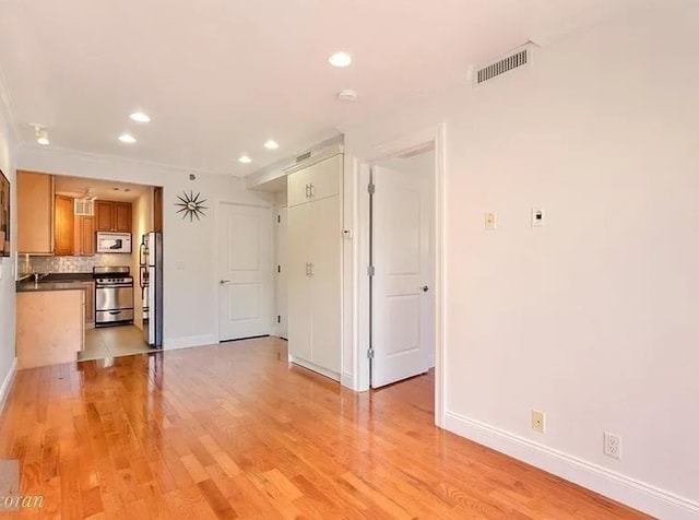 111 W 113th St Unit 4B, New York City, NY 10026 - unfurnished living room featuring recessed lighting and light wood-style flooring