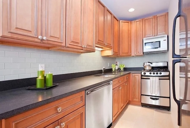 111 W 113th St Unit 4B, New York City, NY 10026 - kitchen featuring appliances with stainless steel finishes, dark countertops, backsplash, light tile patterned floors, and brown cabinets