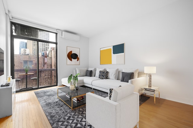 184 Thompson St Unit 5B, New York City, NY 10012 - living area featuring a wall unit AC and hardwood / wood-style floors
