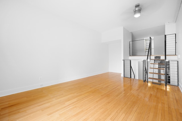 184 Thompson St Unit 5B, New York City, NY 10012 - unfurnished living room featuring wood-type flooring and baseboards