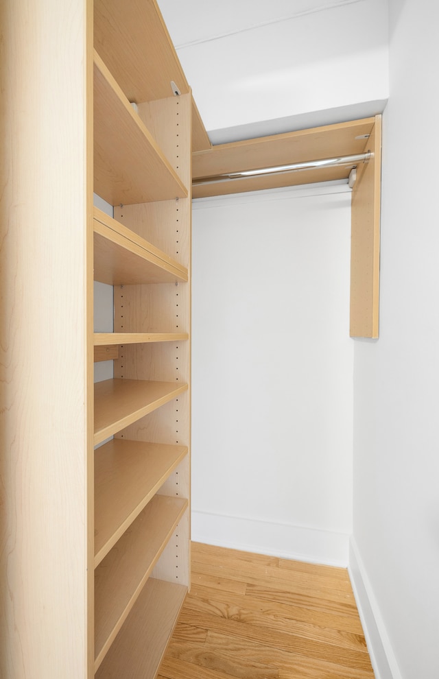 184 Thompson St Unit 5B, New York City, NY 10012 - walk in closet featuring wood finished floors