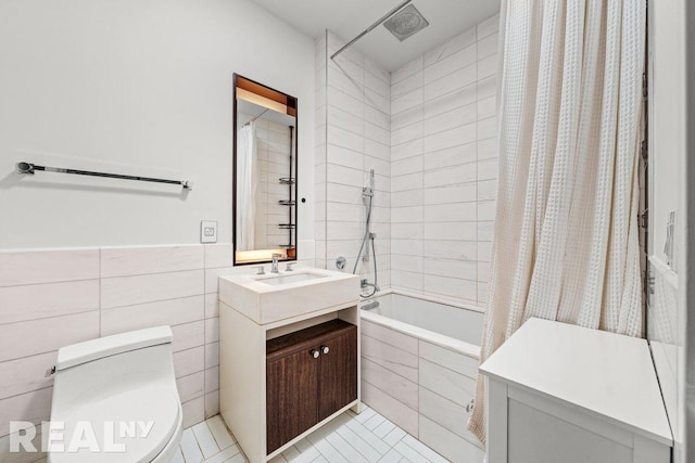 261 W 25th St Unit 8A, New York City, NY 10001 - bathroom with tiled shower / bath, vanity, toilet, tile patterned flooring, and tile walls