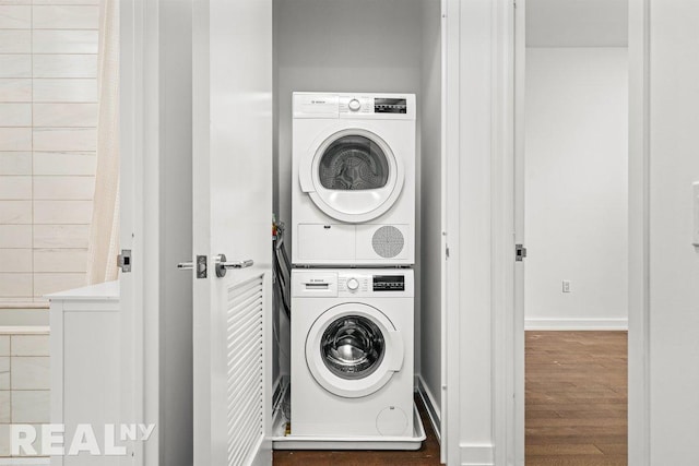 261 W 25th St Unit 8A, New York City, NY 10001 - laundry room with stacked washer and clothes dryer, wood finished floors, and baseboards