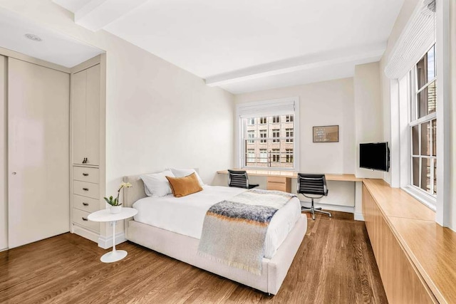 25 E End Ave Unit 10E, New York City, NY 10075 - bedroom featuring wood finished floors, multiple windows, and beamed ceiling