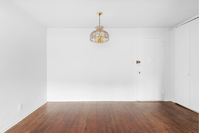 400 E 17th St Unit 608, New York City, NY 11226 - empty room with wood finished floors, a chandelier, and baseboards