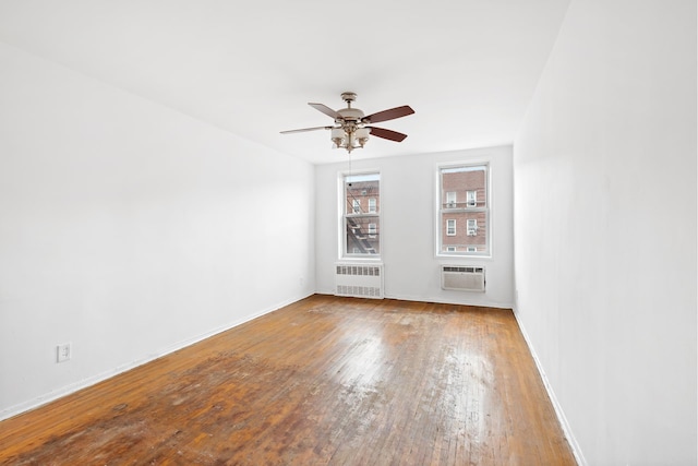 400 E 17th St Unit 608, New York City, NY 11226 - spare room with radiator, ceiling fan, wood finished floors, baseboards, and a wall unit AC