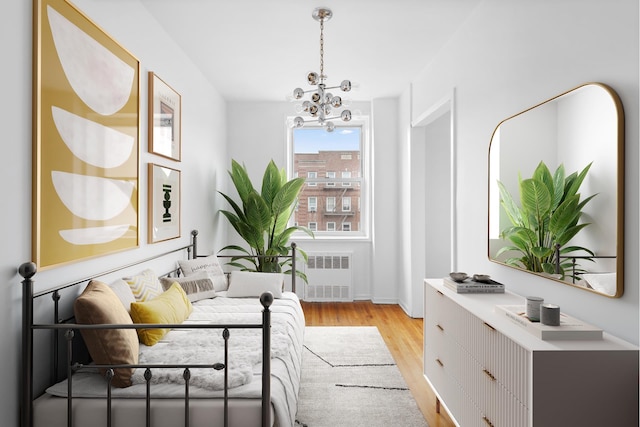 400 E 17th St Unit 608, New York City, NY 11226 - office area featuring radiator, light wood-style floors, a chandelier, and baseboards