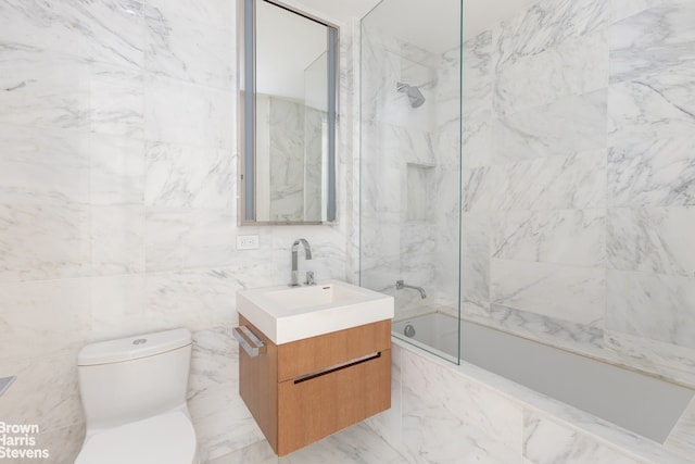 1 W End Ave Unit 18H, New York City, NY 10023 - bathroom featuring vanity, tile walls, a combined bath / shower with marble appearance, and toilet