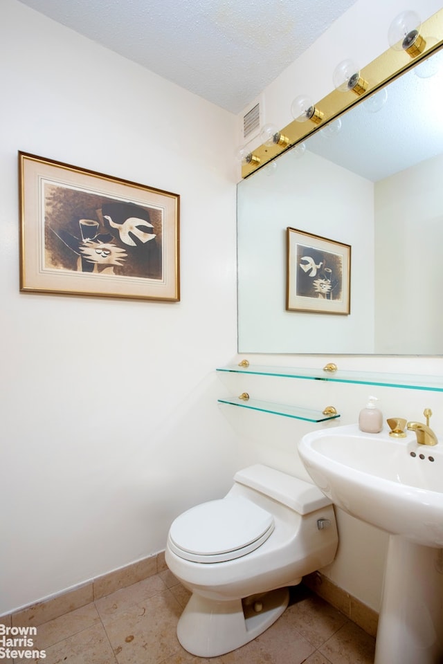 20 W 64th St Unit 20K, New York City, NY 10023 - half bathroom featuring tile patterned floors and toilet