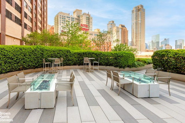 20 W 64th St Unit 20K, New York City, NY 10023 - view of patio / terrace featuring a view of skyline and an outdoor living space with a fire pit