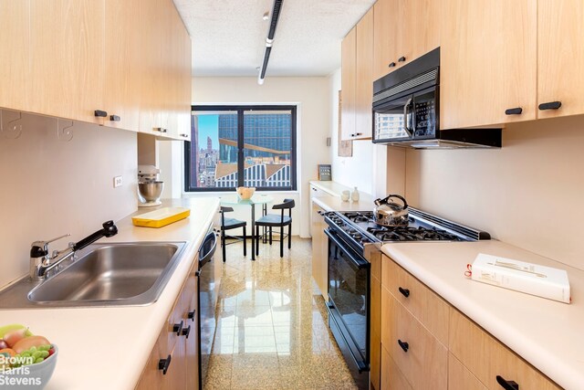 20 W 64th St Unit 20K, New York City, NY 10023 - kitchen with black appliances, light brown cabinets, granite tiled floors, and light countertops