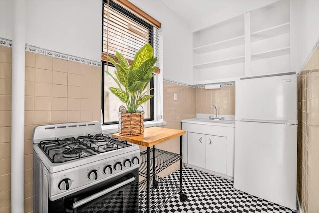 26 W 97th St Unit 3A, New York City, NY 10025 - kitchen featuring white appliances, tile walls, a sink, light countertops, and open shelves