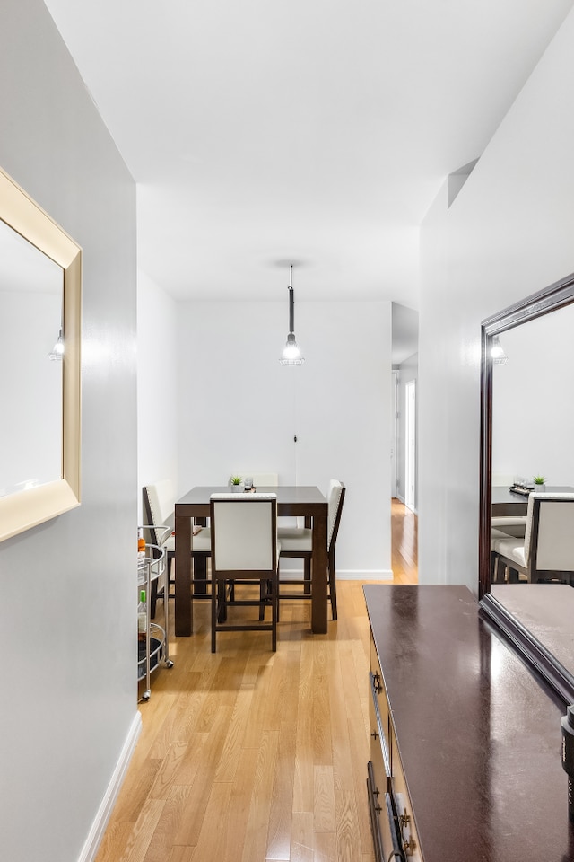 99 John St Unit 524, New York City, NY 10038 - dining space featuring light wood finished floors