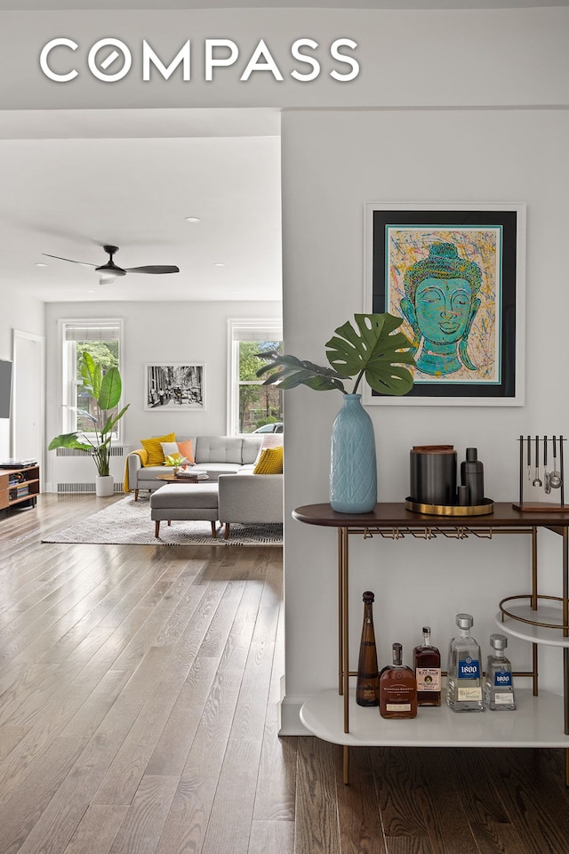 72-17 34th Ave Unit 1P, New York City, NY 11372 - living area with wood finished floors, ceiling fan, and radiator
