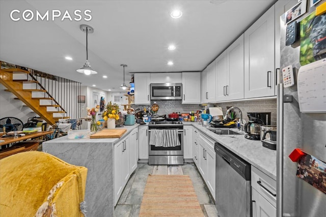 1509 Dean Street Multi, New York City, NY 11213 - kitchen featuring stainless steel appliances, a sink, recessed lighting, tasteful backsplash, and white cabinetry