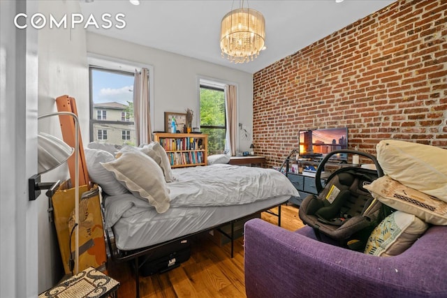 1509 Dean Street Multi, New York City, NY 11213 - bedroom featuring brick wall, wood finished floors, and a chandelier