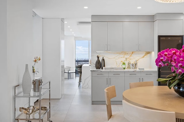 422 E 72nd St Unit 37Ad, New York City, NY 10021 - kitchen featuring tasteful backsplash, light tile patterned floors, light countertops, recessed lighting, and white cabinetry