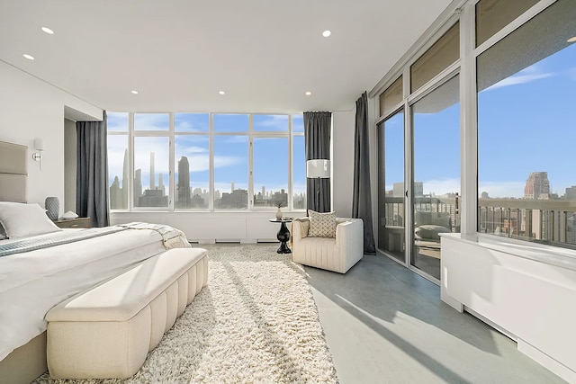 422 E 72nd St Unit 37Ad, New York City, NY 10021 - bedroom with finished concrete flooring, access to exterior, a view of city, multiple windows, and recessed lighting