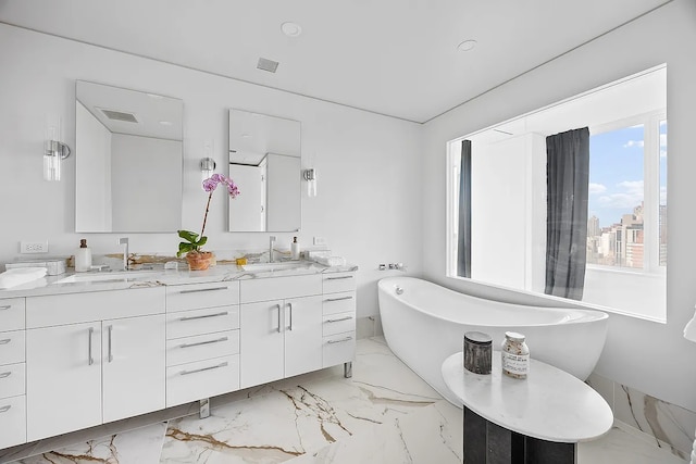 422 E 72nd St Unit 37Ad, New York City, NY 10021 - full bath featuring marble tiled floors, double vanity, a freestanding tub, and recessed lighting