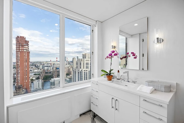 422 E 72nd St Unit 37Ad, New York City, NY 10021 - bathroom with vanity, healthy amount of natural light, a city view, marble finish floors, and recessed lighting