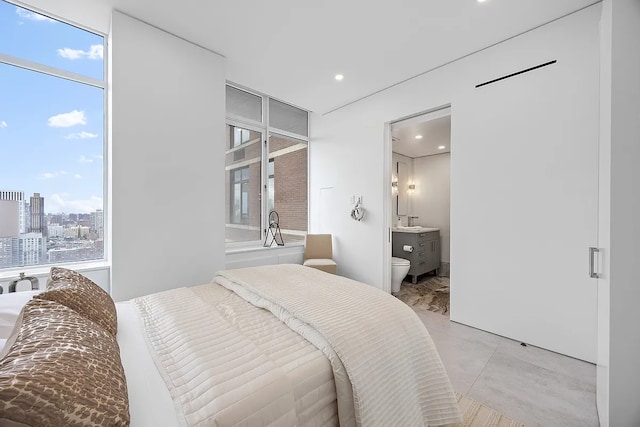 422 E 72nd St Unit 37Ad, New York City, NY 10021 - bedroom featuring recessed lighting, ensuite bath, and a sink