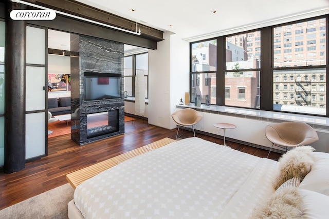345 W 13th St Unit Ph6B, New York City, NY 10014 - bedroom featuring wood finished floors and a glass covered fireplace