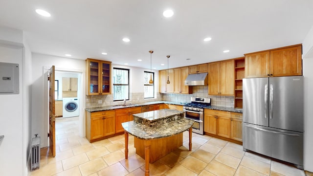 93A Rutland Rd, New York City, NY 11225 - kitchen featuring appliances with stainless steel finishes, washer / dryer, under cabinet range hood, electric panel, and open shelves